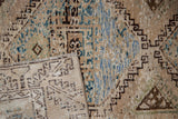 Distressed Oushak rug pile with exposed foundation, geometric patterns, and hand-knotted reverse.