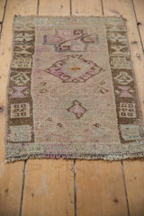 The soft, distressed pile and asymmetric design of a vintage Turkish Kars rug in mauve and brown.