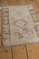 Angled view of a distressed Kars rug with a low, even pile and geometric border.