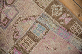 Folded corner of a vintage Kars rug showing the hand-knotted foundation and pile texture.