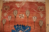 Distressed vintage Oushak rug with arts and crafts floral motifs, dusty brick red, cobalt blue.