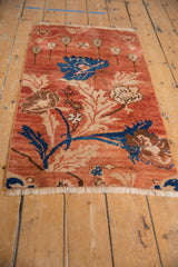 White fringe and blue, beige arts and crafts florals on a vintage Oushak rug runner.