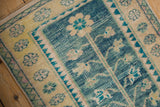 Abrashed ocean blue field, pale saffron floral border, and turquoise zig-zag on vintage Oushak rug.
