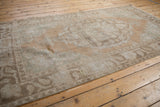 Close-up of distressed vintage Oushak rug, low pile, foundation, Rococo pattern: sandalwood, seafoam.
