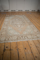 Textural variation on a distressed Oushak rug corner, revealing Rococo stylized motifs.