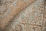Distressed pile, visible knot heads on vintage Oushak rug, sandalwood and seafoam green.