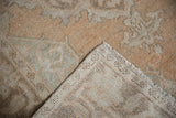 Distressed Oushak rug's pile, knot heads, and hand-knotted foundation with fringe.