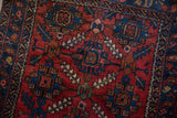 Lilihan rug's fine wool pile showcasing ruby red, sapphire blue, and palmette vine motifs.