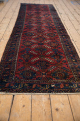 Lilihan rug with ruby red field, allover trellis palmette design, and navy blue vine border.