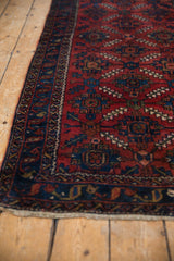 Lilihan rug with sapphire blue meandering vine border and ruby red field with serrated leaves.