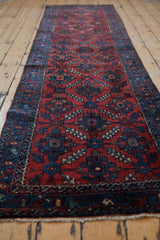 Hand knotted Lilihan runner fringe detail with sapphire blue vine border and ruby red field.