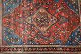 Antique Farahan Sarouk rug: fine knotting revealing a diamond medallion and sapphire floral vines.