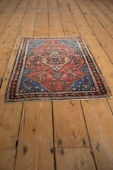 Fine hand-knotted antique Farahan Sarouk rug, intricate floral vines, brick red, sapphire blue.