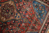 Fine hand-knotted pile revealing intricate Farahan Sarouk vines and buds in red and blue.