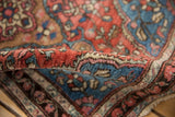 Intricate fine knotting and plush pile of the antique Farahan Sarouk, with brick red and blue.