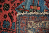 Vintage Mehreban rug detail: textured raspberry pile, tightly woven trefoil pawn border, and fringe.