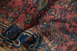 Vintage Lilihan rug showing fine texture, dusty red floral field, indigo border.