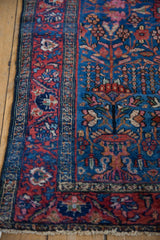 Lilihan rug detail: painted red border and sapphire blue field with blossom motifs.