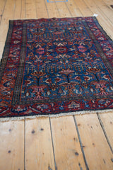 Finely woven Vintage Lilihan rug with germinating blossom design, sapphire blue, and painted reds.