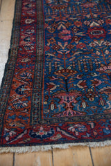 Traditional vintage Lilihan rug: angled view of fine indigo and raspberry blossom motifs.