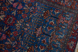 Vintage Persian Lilihan rug close-up: fine weave, sapphire blue field, germinating blossom motifs.