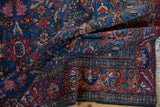 Folded Lilihan rug: fine germinating blossom, high luster sapphire blue wool pile.