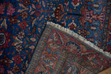 Vintage Lilihan rug with sapphire blue blossom pile, revealing its contrasting red woven back and fringe.