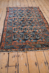 Antique Hamadan rug corner, with fringe, serrated leaf border, and shrimp motif in cobalt blue and dusty copper.