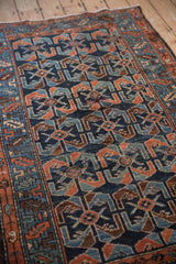 Cobalt blue field with dusty copper shrimp and floral blossom motifs on an antique Hamadan rug.