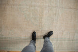 Worn pile texture of the distressed vintage Oushak rug in ivory, cream, and seafoam green.
