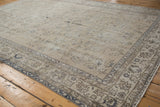 Faded blue vinery and border detail on a distressed vintage Sparta carpet with even wear.
