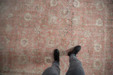 Distressed vintage Sivas carpet with rose, ivory, oxidized silver tones, and faded palmette pattern.