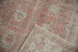 Folded vintage Sivas carpet detail: distressed rose pile, visible wear, and woven foundation.
