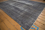A detailed view of the distressed Oushak carpet showing mostly even wear to the knot heads.