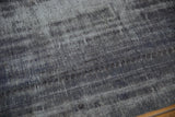 Even wear across the knot heads of a vintage overdyed charcoal Oushak carpet.