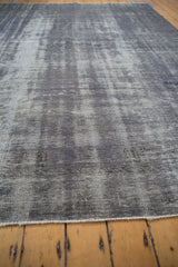 Dynamic wear and texture across the pile of a distressed, overdyed charcoal Oushak carpet.