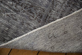 Detail of a vintage Oushak carpet showing the fully secured side and hand-knotted foundation.