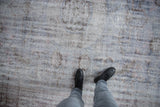 Distressed Oushak carpet texture with low pile, exposed foundation, dusty blue and mauve.