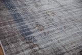 Worn texture of distressed Oushak rug, showing exposed foundation and muted dusty blue.