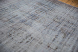 Distressed Oushak rug detail reveals worn texture, visible foundation, and muted blue-mauve shades.