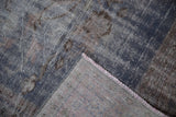 Hand-knotted distressed Oushak carpet detail, dusty blue and mauve wear revealing foundation.