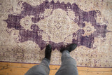 Distressed vintage Turkish Sparta rug with aubergine and ivory tones, showing visible knot heads.