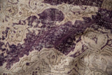 Worn aubergine and ivory tones revealing foundation texture of a vintage Sparta rug.