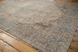Worn texture and delicate vinery with pale teal and aubergine on this vintage Turkish Sparta carpet.