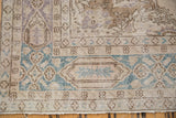 Distressed Sparta carpet corner with faded dusty teal border and antique ivory vinery.