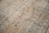 Distressed pile of vintage Turkish Sparta rug with delicate vinery in pale teal and ivory.