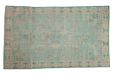 Distressed Oushak carpet with faded pale turquoise and ivory arts and crafts medallion.