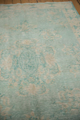 Pale turquoise and sand distressed vintage Oushak rug, showing wear and faint foundation.