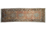 Distressed vintage Oushak runner, central medallion, geometric motifs in dusty rose and coffee brown.