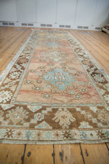Distressed Oushak runner showcasing abrashed dusty rose field with pale gold and coffee brown border motifs.